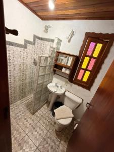 a bathroom with a toilet and a sink at Villa da Vila in Monte Verde +118 photos