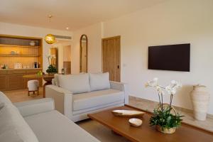 a living room with a couch and a table at Kimpton Tres Rios - All Inclusive in Playa del Carmen