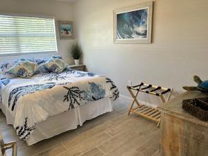 a bedroom with a bed and a window at Conch Shell Cabana in Vero Beach