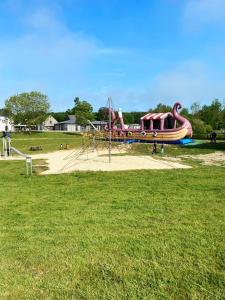 a playground with a slide in a park at Mobile home in Litteau