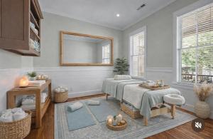 a living room with two beds and a mirror at Inn on Turner in Oriental