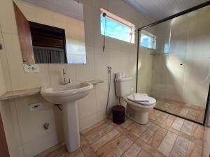 a bathroom with a sink and a toilet at Villa da Vila Montanhas in Monte Verde +65 photos