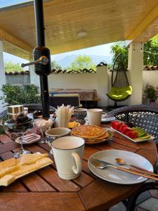 a wooden table with plates of food on it at Leila's Guest House in Joqolo