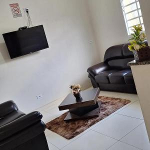 a living room with a couch and a table at Hotel Cardoso Trindade in Juruaia