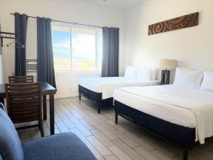 a hotel room with two beds and a window at Unit 26 Waena Inn - Maui Private Suite in Wailuku