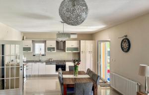 a kitchen and dining room with a table and chairs at Stunning Home In Sinj in Sinj