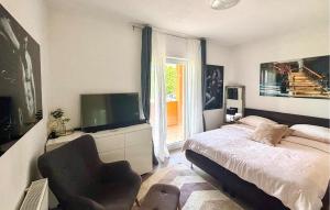 a bedroom with a bed and a television and a chair at Stunning Home In Sinj in Sinj