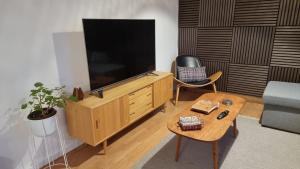 a living room with a large television and a coffee table at Casa del Amor in Hyldtofte +13 photos