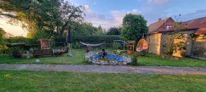 a backyard with a fire pit in the grass at Casa del Amor in Hyldtofte
