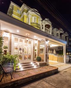 a building with a bench in front of it at night at The Lek Aree in Bangkok