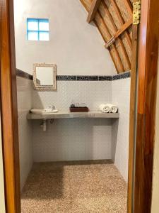 a bathroom with a sink and a mirror at Griya Garden Penida in Nusa Penida +17 photos