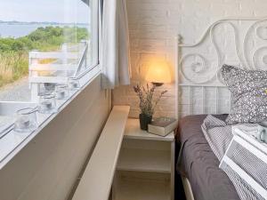 a bedroom with a bed and a window with a view at 4 person holiday home in Aabenraa in Aabenraa +21 photos