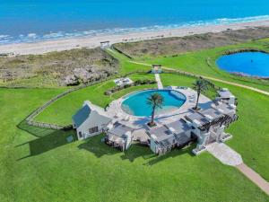 an aerial view of a house on the beach at Luxury Beachfront Ocean Views Pool Access Sleeps15 in Bolivar Peninsula