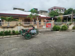 a horse drawn carriage parked in front of a house at Ancestral BATO in Bato +4 photos
