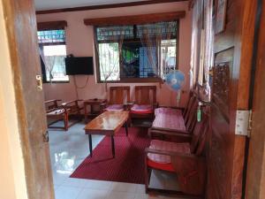 a room with a table and chairs in a room at Ancestral BATO in Bato