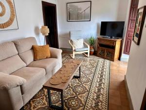 a living room with a couch and a table at Casa del Delfin in Iznájar