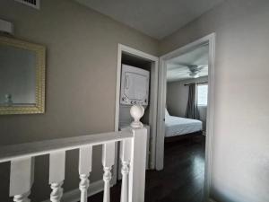 a room with a staircase with a bed and a mirror at Best location Cozy condo in Biloxi Beach in Biloxi