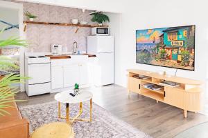 a kitchen with a white refrigerator and a table at Sweet Stowe Apartment in Stowe