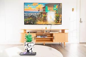 a living room with a tv on a wall at Sweet Stowe Apartment in Stowe