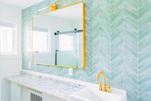 a bathroom with a sink and a mirror at Sweet Stowe Apartment in Stowe +15 photos