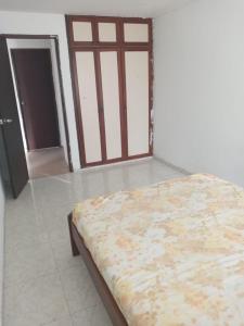 a bedroom with a bed in a room with a door at LaHouse in Cali