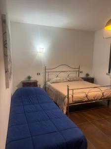 a bedroom with a bed with a blue blanket at Trevisan in Cerea +27 photos