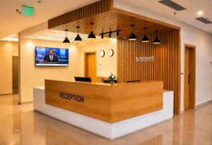 an office lobby with a reception desk and a television at Bosaso Airport Hotel in El Ad