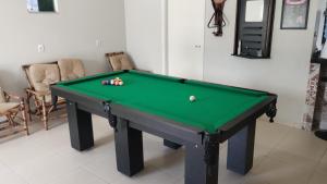 a green pool table with balls on top of it at Chacara Urbana in Navegantes