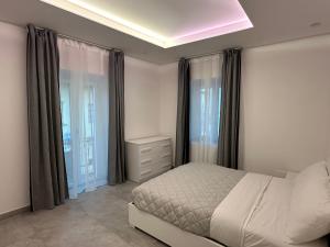 a bedroom with a bed and a large window at Residenza del Lago in Viverone