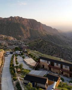 a building with a tennis court in front of a mountain at Dana Trail Hotel in Dana +68 photos