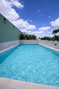 a swimming pool with blue water in a building at Casa Trova Santa Lucía with Parking by Cercana in Mérida