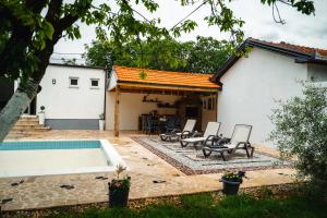 a backyard with a pool and a house at PIK Residence in Mostar