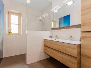 a bathroom with a sink and a mirror at Das Rendlgut Top 3 in Lofer