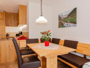 a kitchen and dining room with a wooden table and chairs at Das Rendlgut Top 3 in Lofer