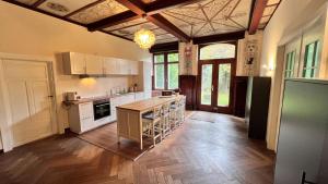 a kitchen with white cabinets and a wooden floor at Zum Hölltor in Überlingen
