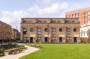 a large brick building with benches in front of it at Modern Townhouse Birmingham in Birmingham