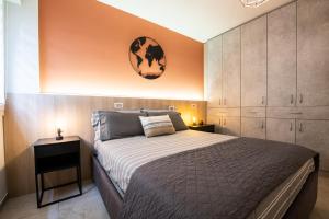a bedroom with a bed and a clock on the wall at Renzi 23 in Cattolica