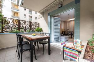 a patio with a table and chairs on a balcony at Renzi 23 in Cattolica
