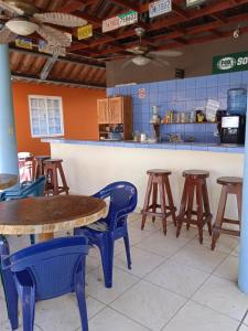 a restaurant with wooden tables and chairs in front of a counter at Sunrise Inn in Puerto Armuelles