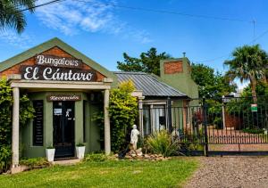 a woman walks in front of a building at El Cantaro in Villa Elisa +3 photos