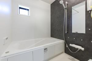 a bathroom with a bath tub and a shower at AsobiStay児玉藤 in Nagoya +41 photos