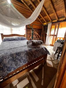 a bedroom with a bed in a wooden cabin at Rustic Cabin in Salento in Salento