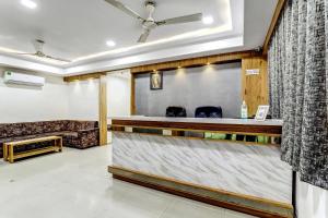 a bar in a room with a counter at Hotel O Maple view in Naroda