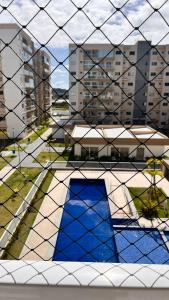 a view from a window through a wire fence at Aprt com ar varada conjugada,piscina in Aracaju