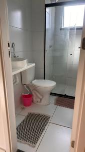 a bathroom with a toilet and a glass shower at Aprt com ar varada conjugada,piscina in Aracaju +14 photos