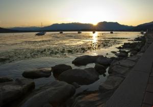 a group of rocks on the beach at sunset at Romantic Spa del Lago in Viverone +4 photos