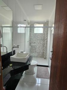 a bathroom with a sink and a toilet and a shower at Zanotti's House in Santa Teresa +12 photos
