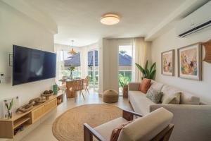 a living room with a large flat screen tv at Oceanfront Paradise Beach Resort Escape in San Felipe de Puerto Plata