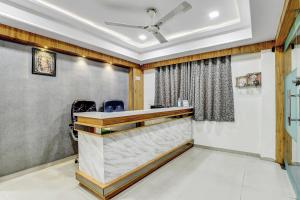 an office with a reception desk in a room at Hotel O Maple view in Naroda