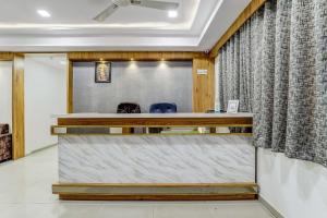 a meeting room with a desk and two chairs at Hotel O Maple view in Naroda